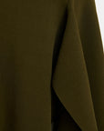 Close-up of a dark olive green draped fabric, showing the texture and a folded corner.