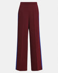 A pair of high-waisted, wide-leg trousers in deep burgundy with vibrant blue side stripes, shown against a plain light gray background.