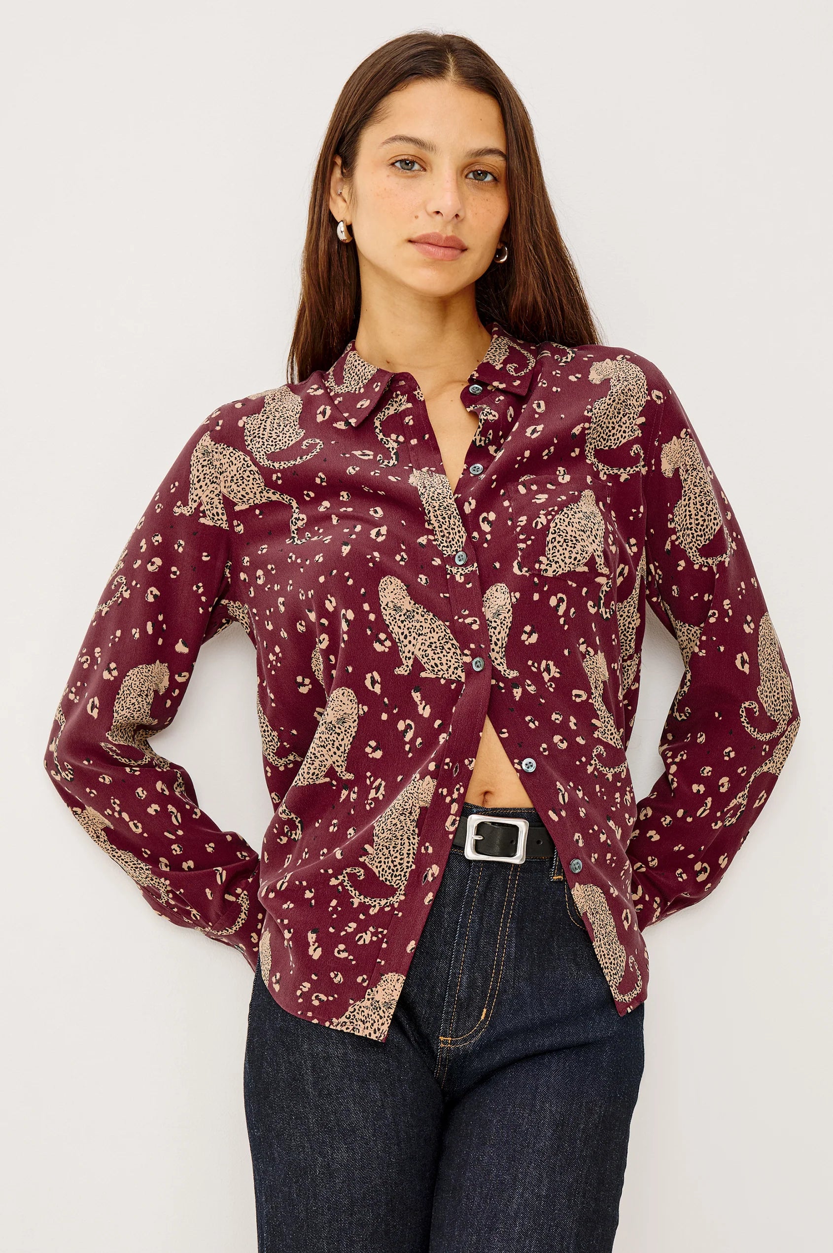 Woman wearing a patterned shirt with a plain background