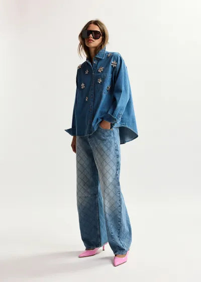 Person wearing a blue denim outfit with a white background