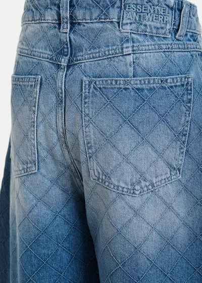 Close-up of blue jeans with a diamond pattern on the back pocket, featuring the brand 'Essential Antwerp'.