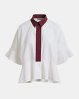 White shirt with a burgundy collar on a white background