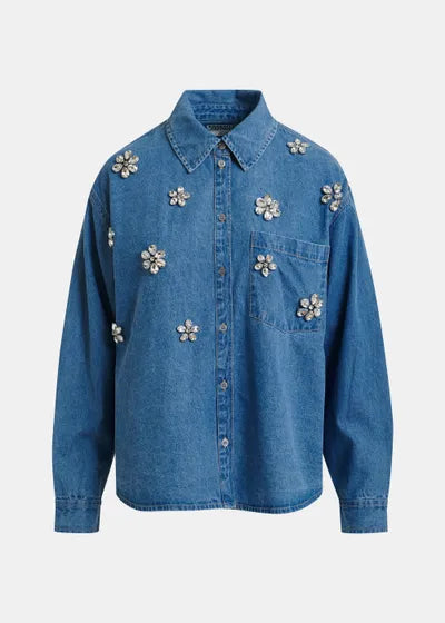 Blue denim shirt with floral embellishments on a white background