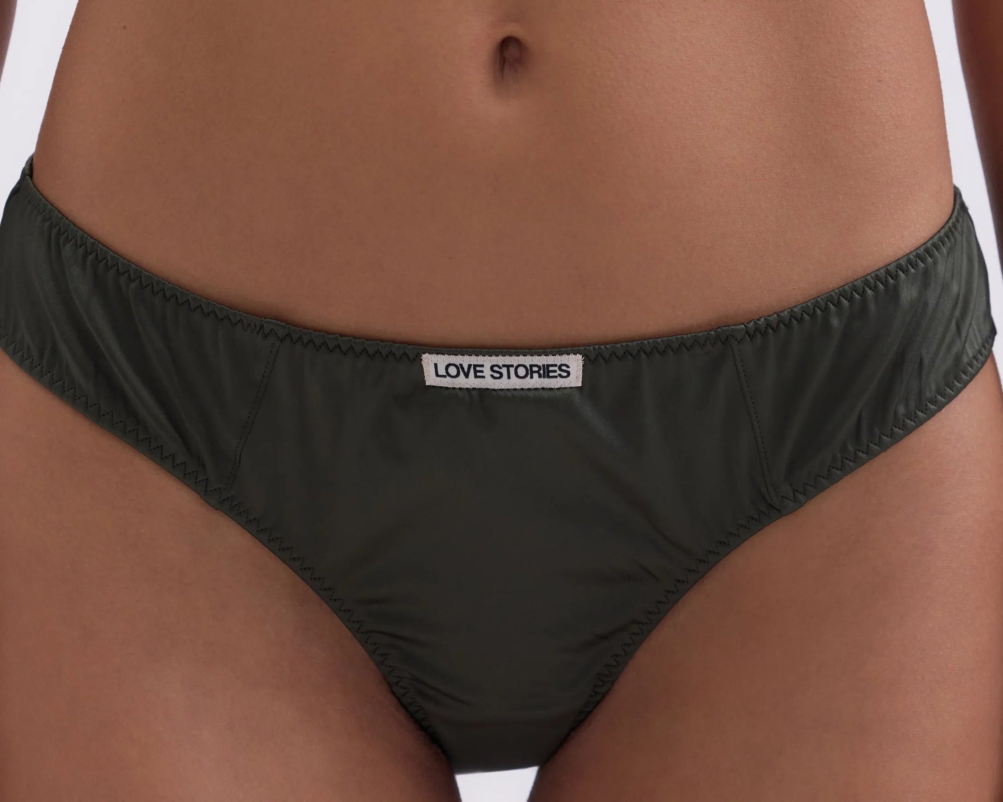 Black underwear with a brand label on a person's waist.