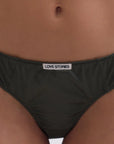 Black underwear with a brand label on a person's waist.
