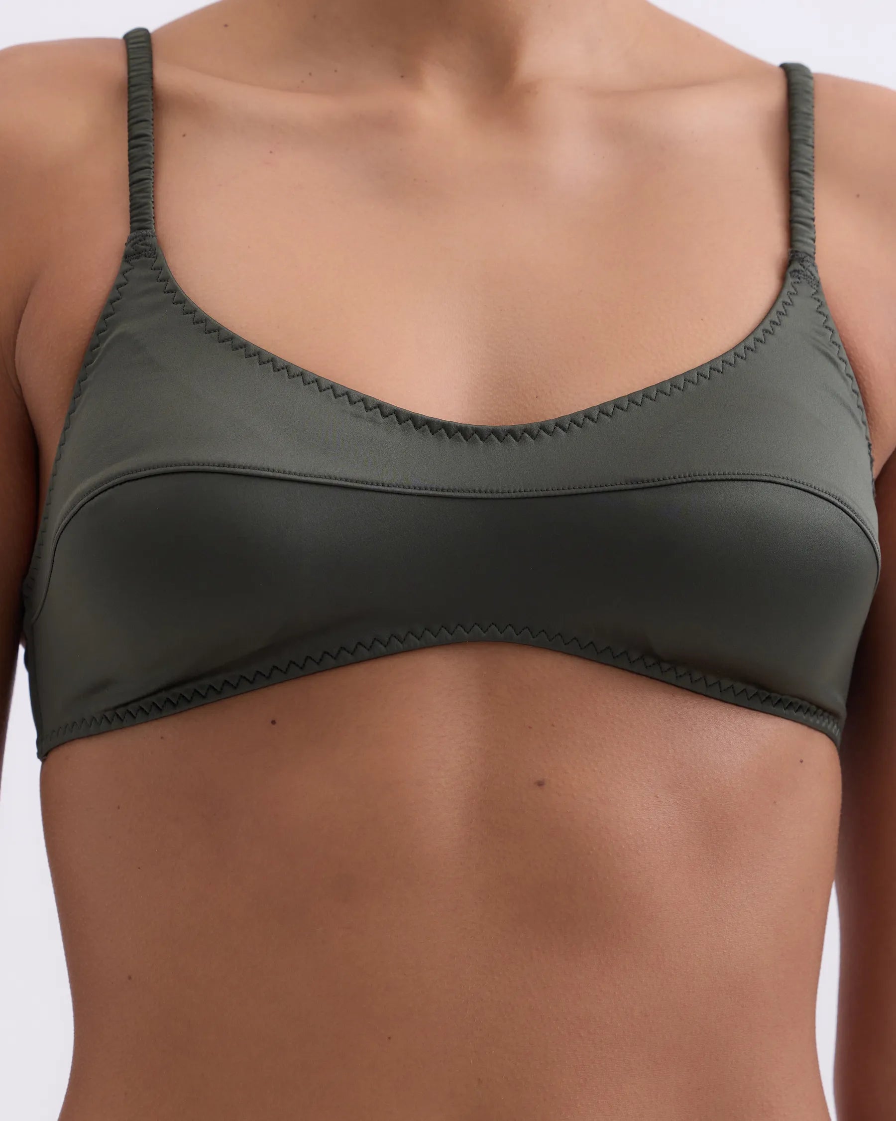 Green bra on a plain background
