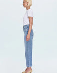 Person wearing a white t-shirt and light blue jeans on a white background