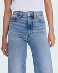 Light blue jeans worn by a person on a white background