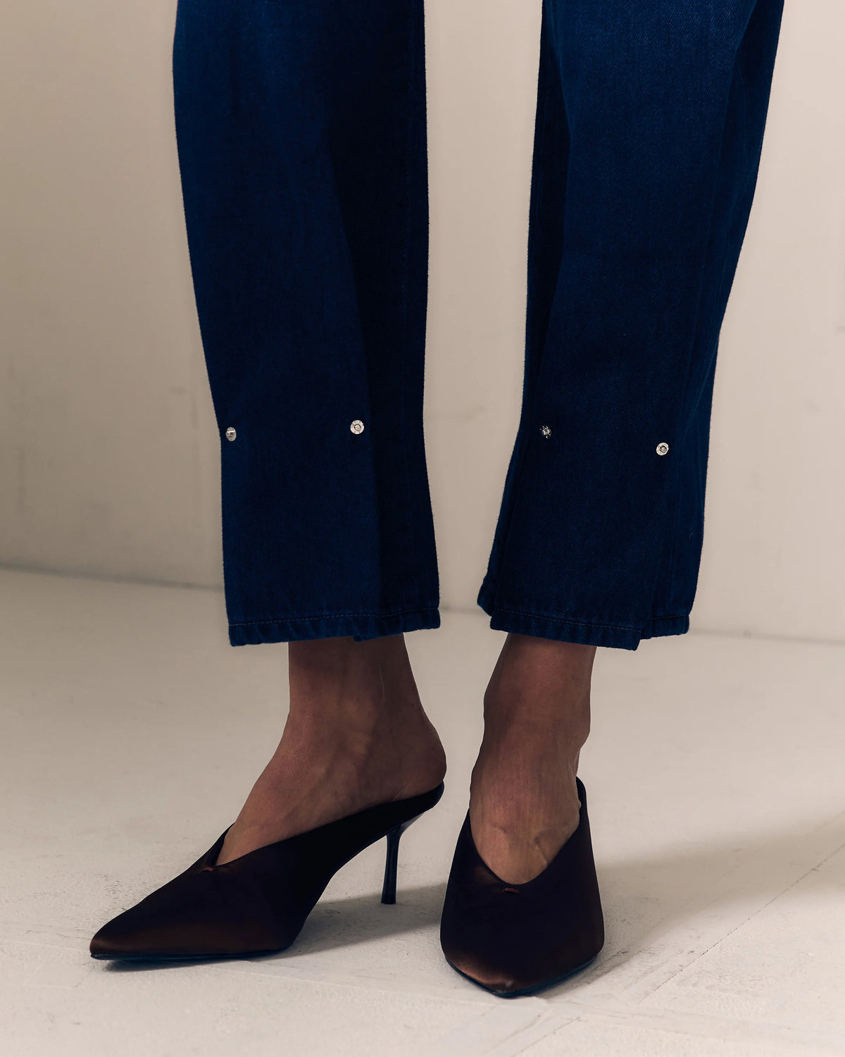 detail close up of pinched hem towards the bottom of the jean leg 