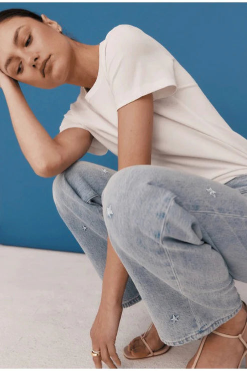 Lexi Mid Rise Bowed Straight model crouched down