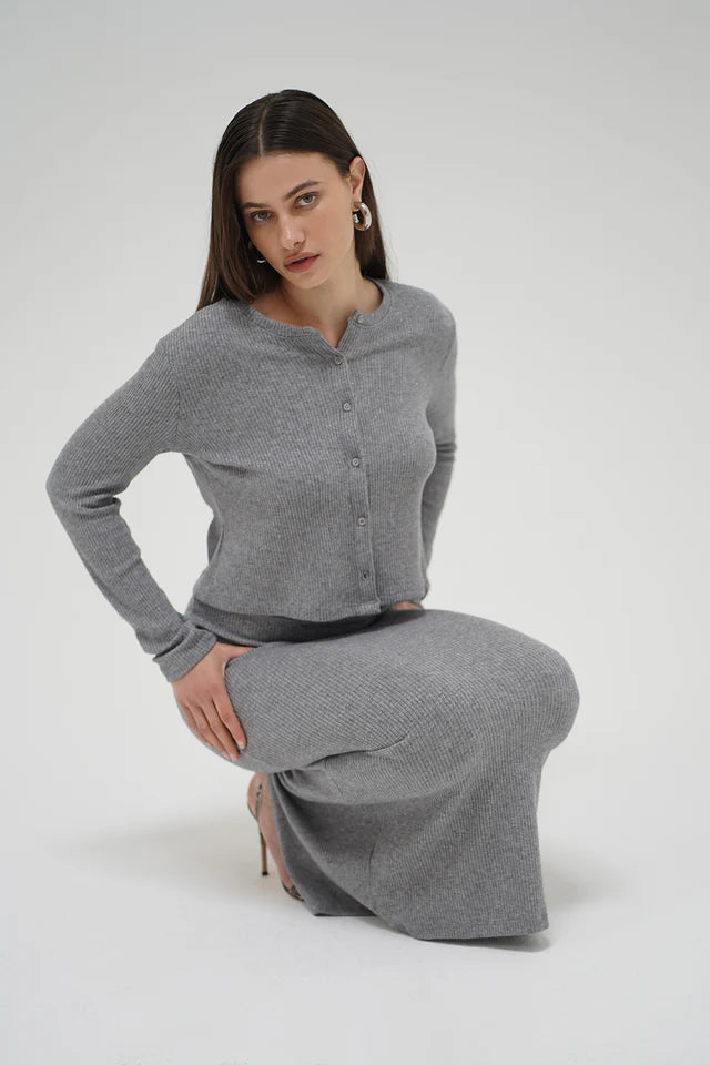 Woman wearing a gray outfit on a white background