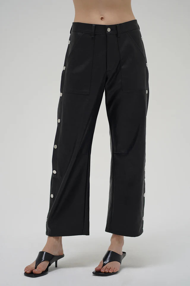 Black wide-leg pants with button details on a white background front view