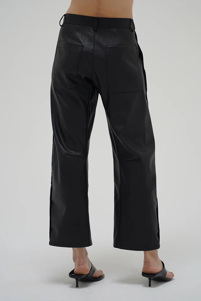 Black pants worn by a person on a white background back view