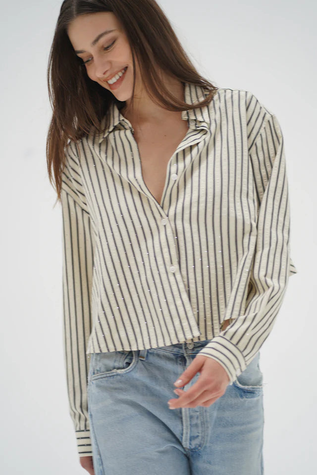 Woman wearing a striped shirt and jeans on a white background front view
