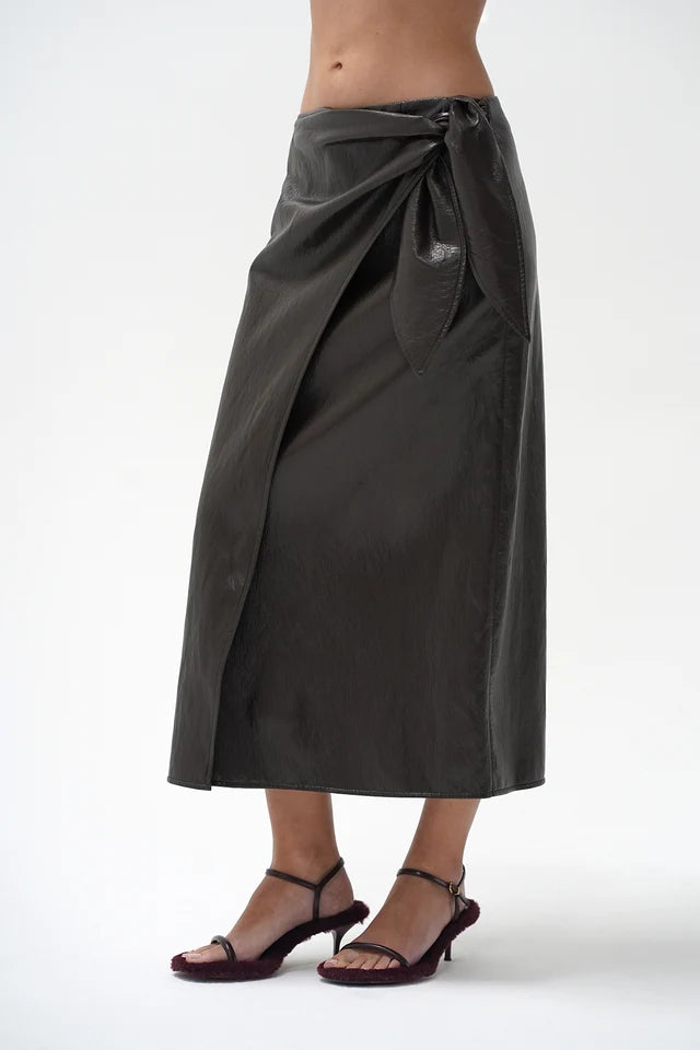 model wearing a brown wrap skirt on a white background