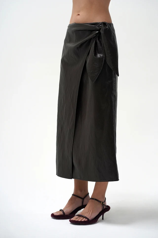 model wearing a brown wrap skirt on a white background