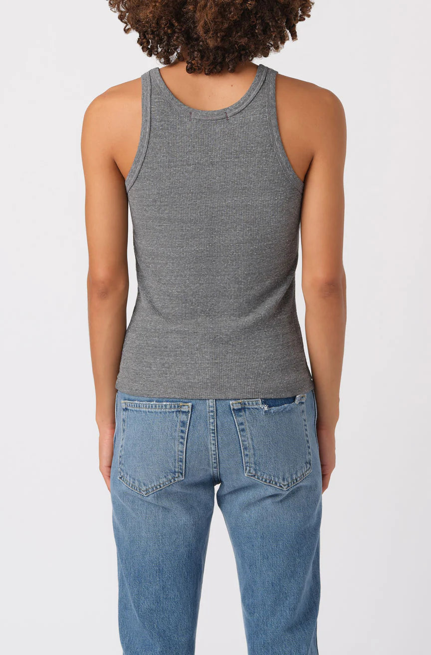 Person wearing a gray tank top and blue jeans on a white background