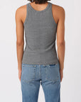 Person wearing a gray tank top and blue jeans on a white background