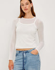 Person wearing a white long-sleeve top and blue jeans on a plain background front view