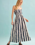 Woman wearing a blue and white striped dress on a light blue background