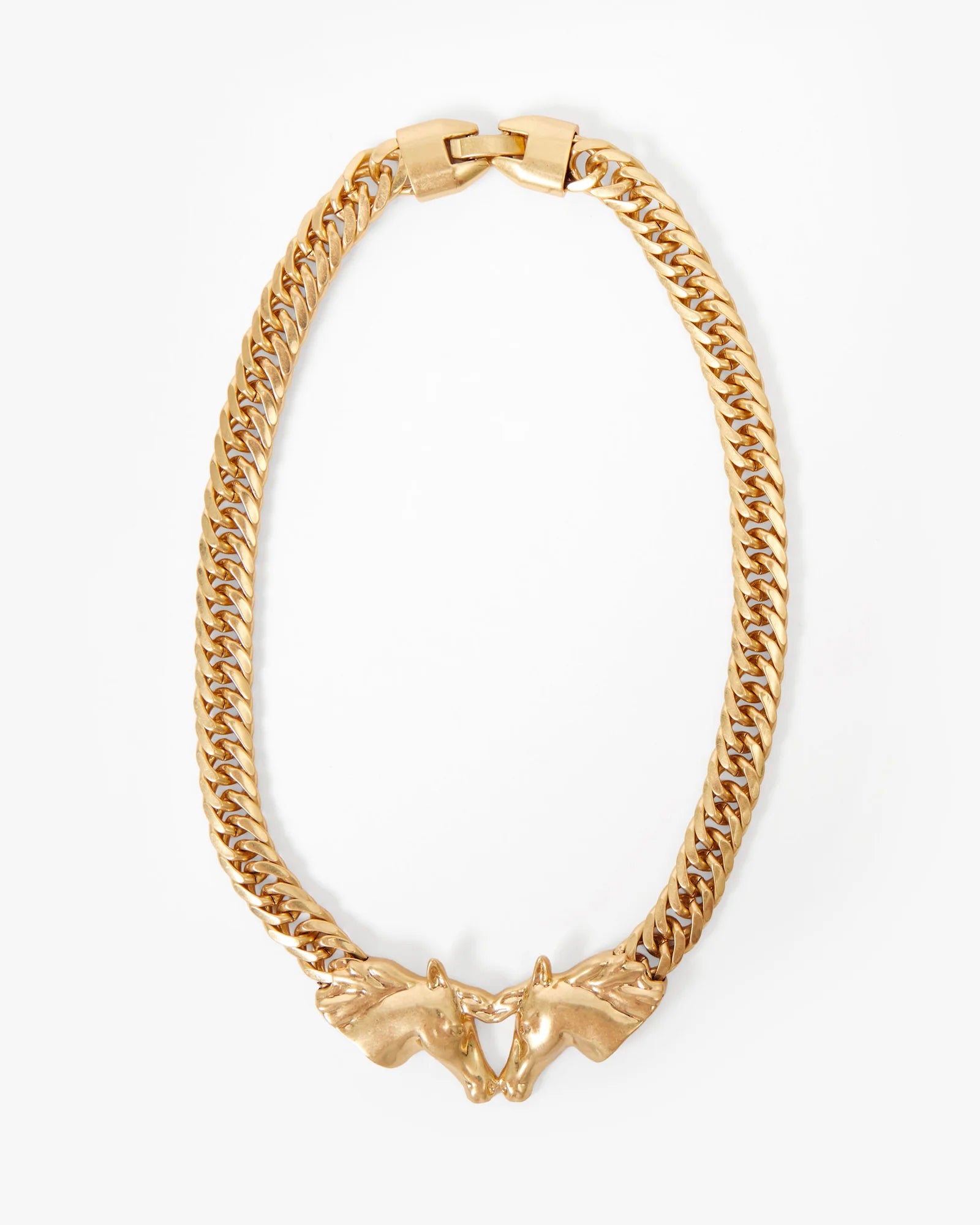 Gold chain necklace with a unique clasp design on a white background