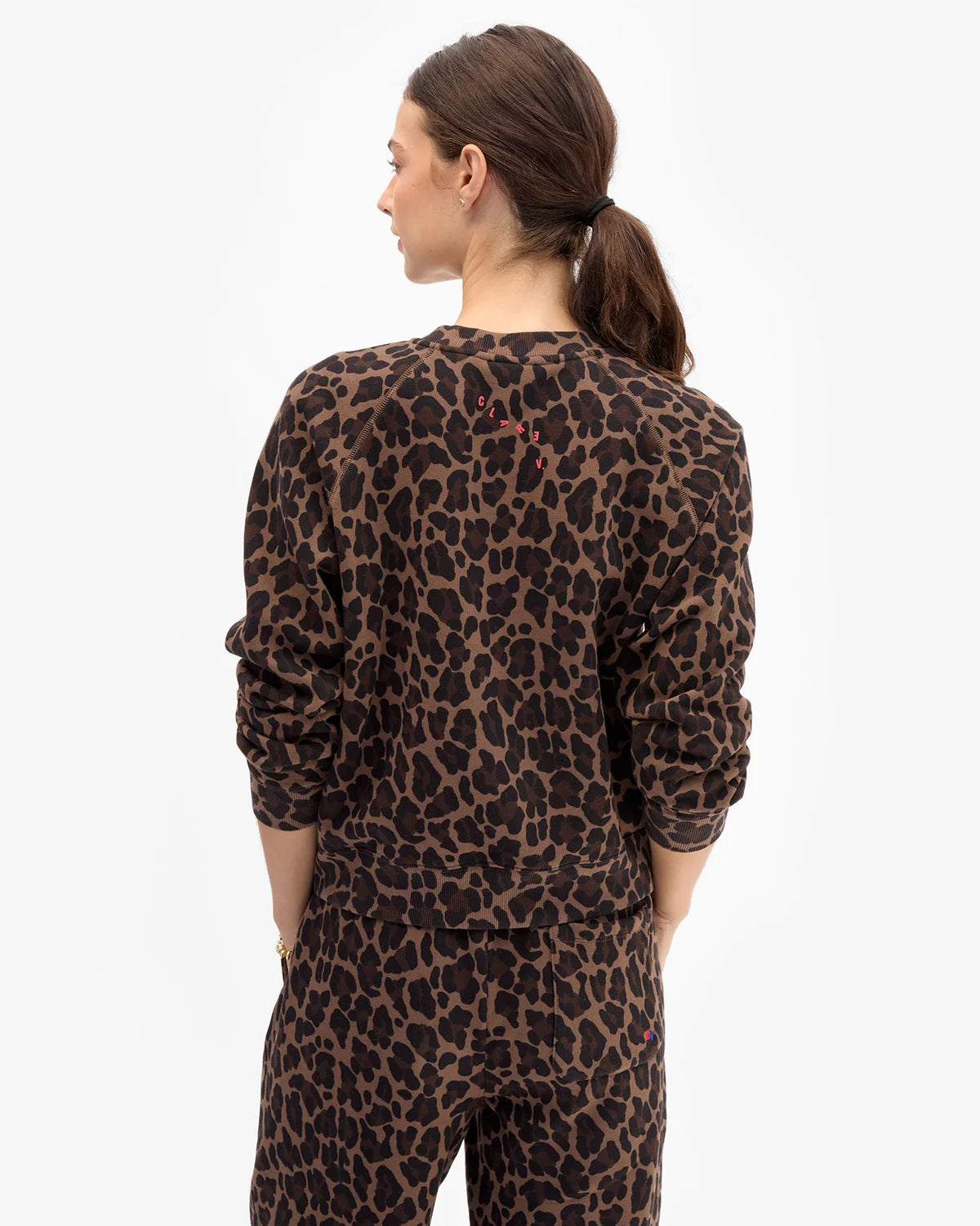 model wearing a matching leopard print sweatshirt set
