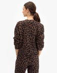 model wearing a matching leopard print sweatshirt set