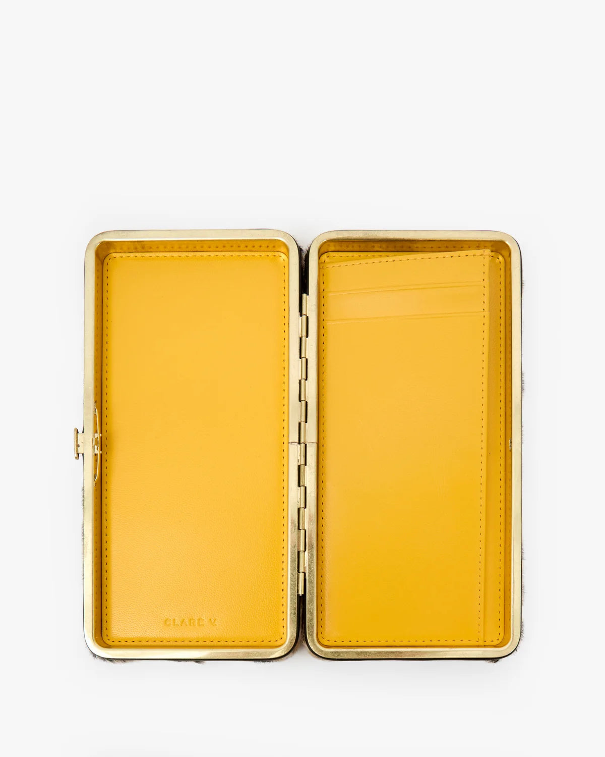 clutch open showing yellow interior on a white background 