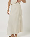 Person wearing a beige skirt on a white background