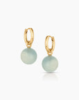 Gold hoop earrings with aquamarine round stones on a white background