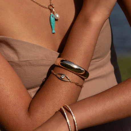 Lumi Cuff Bracelet in Gold front view on model paired with other bracelet
