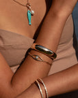 Lumi Cuff Bracelet in Gold front view on model paired with other bracelet