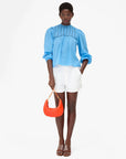 Lune Purse front view with model holding on to purse handle