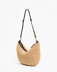 Beige handbag with black strap on a white background