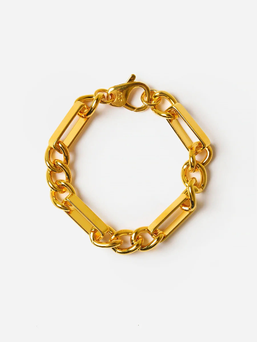 gold-tone chain link bracelet featuring rectangular bar links alternating with smaller oval links, set against a clean white background.