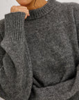 close up of model wearing a grey sweater