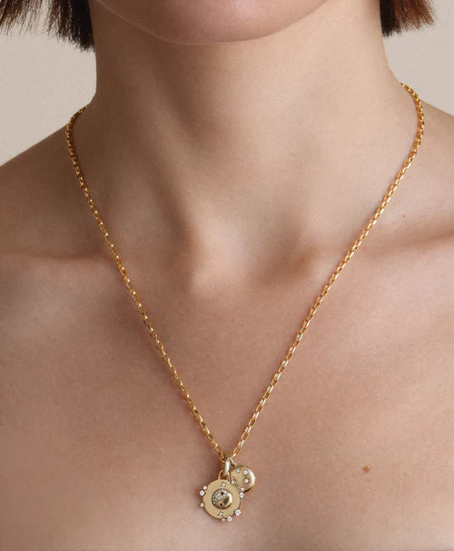 2mm Italian Chain Link Necklace with a pendant on a person's neck against a neutral background