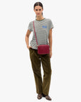 model wearing a striped tee with OUI on chest