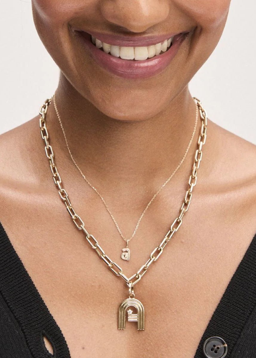 Woman wearing gold necklaces with a pendants and beads