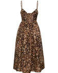 A sleeveless midi dress with thin spaghetti straps and a smocked bodice, featuring an abstract organic pattern in shades of brown, beige, and black, shown against a plain white background.