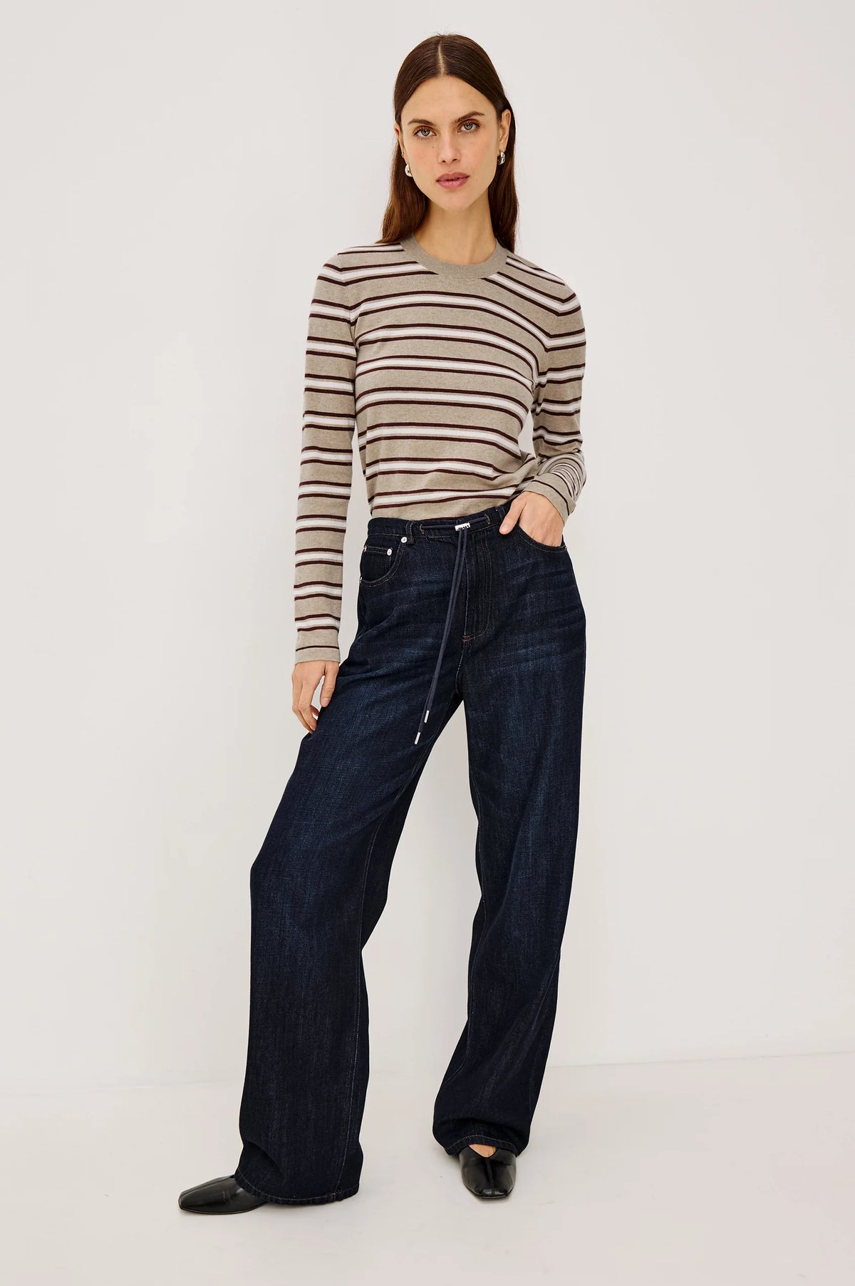 denim tie waist pant worn by a model with a stripe shirt on a grey background