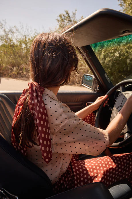 Woman driving a car with a scenic background