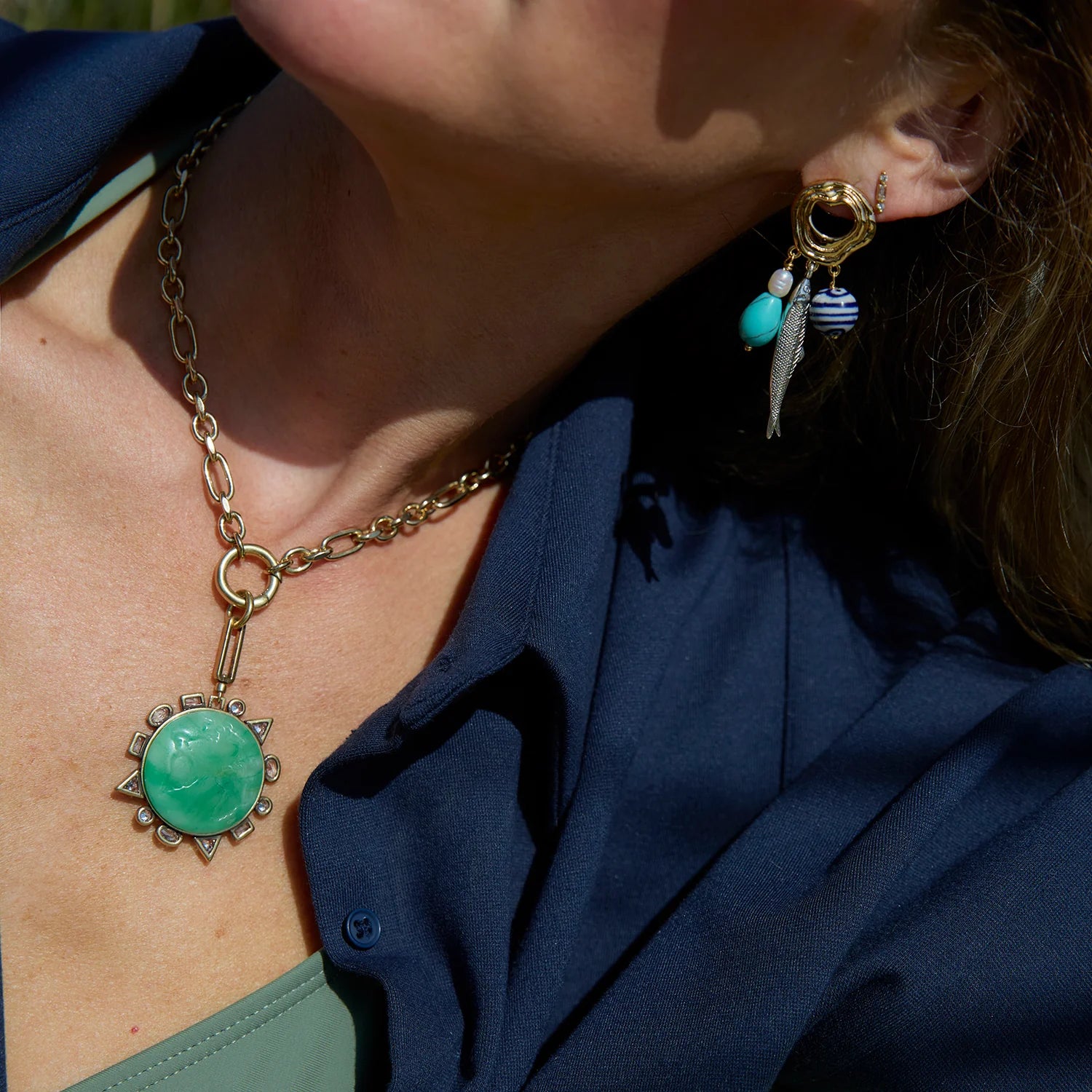 Odyssey Link Necklace in Green front view on model with fish earrings