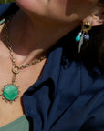 Odyssey Link Necklace in Green front view on model with fish earrings