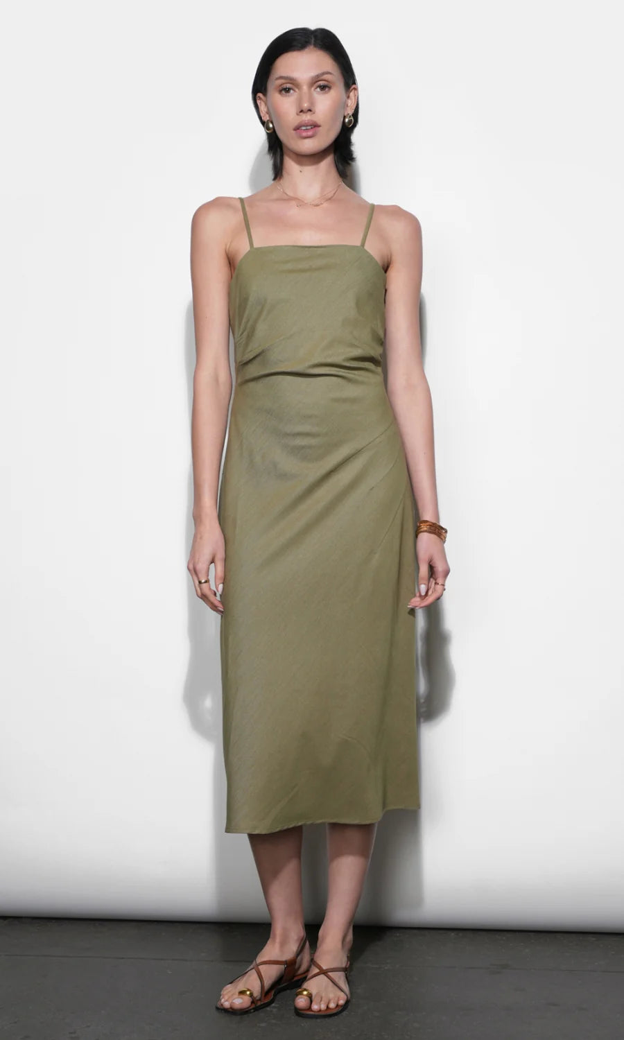 Woman wearing a green dress against a white background