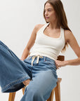 Jadyn Mid Rise Drawstring Palazzo Jean model sitting in chair