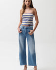 Woman wearing a striped top and blue jeans on a white background