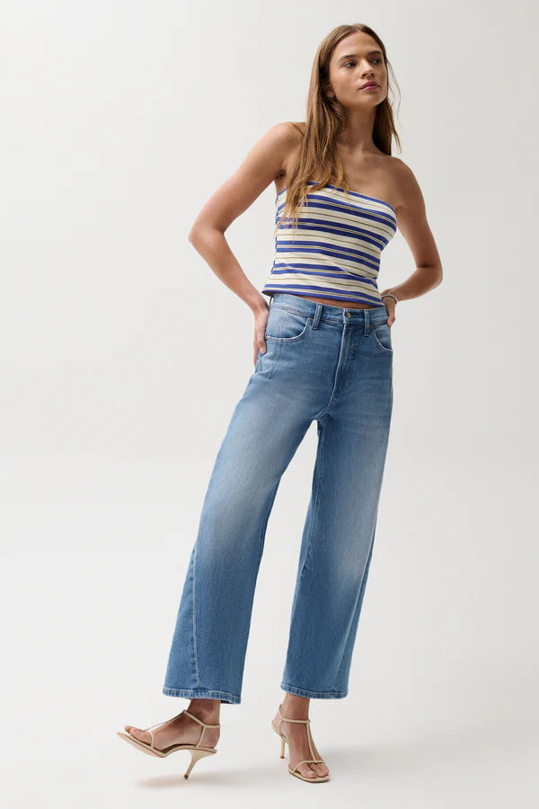 Woman wearing a striped top and blue jeans on a white background, full body front