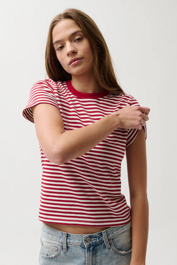 Woman wearing a red and white striped shirt with a plain background