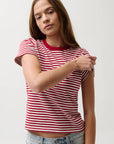 Woman wearing a red and white striped shirt with a plain background